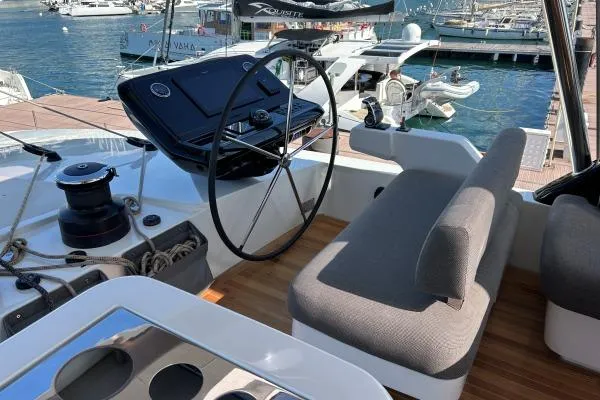 Maty Yacht Photos Pics 2023 Lagoon Seventy 7 yacht helm with modern controls and seating at marina.