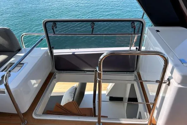 Maty Yacht Photos Pics 2023 Lagoon Seventy 7 yacht interior with open hatch and wooden stairs, overlooking the sea.
