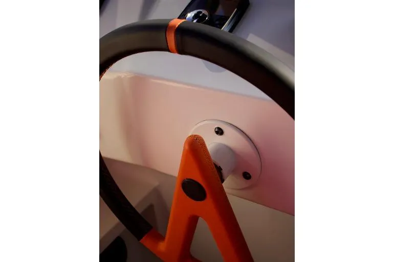  Yacht Photos Pics Steering wheel of 2018 Vanquish Yachts VQ 45, featuring sleek design and orange accents.