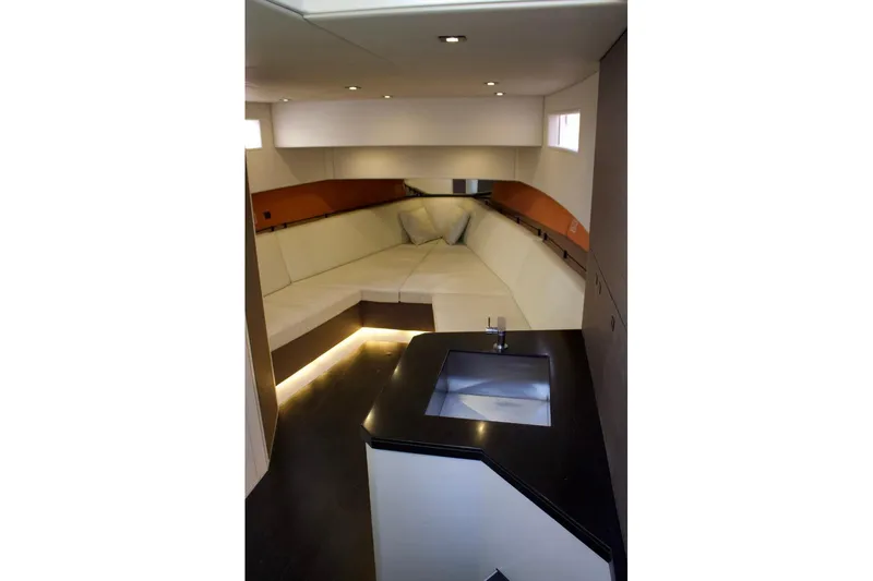 Yacht Photos Pics Interior of 2018 Vanquish Yachts VQ 45, featuring modern seating and sleek kitchenette.