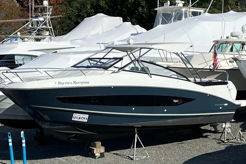  Yacht Photos Pics 2023 Beneteau Flyer 10 boat on display in a marina setting.
