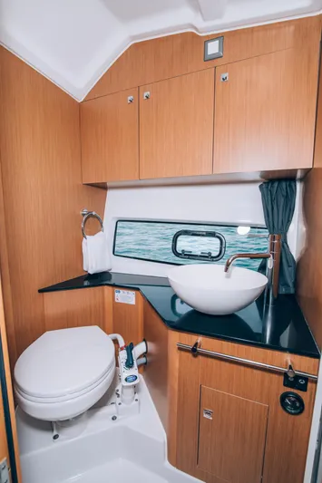  Yacht Photos Pics 2023 Beneteau Flyer 10 bathroom with modern fixtures and wood cabinetry.