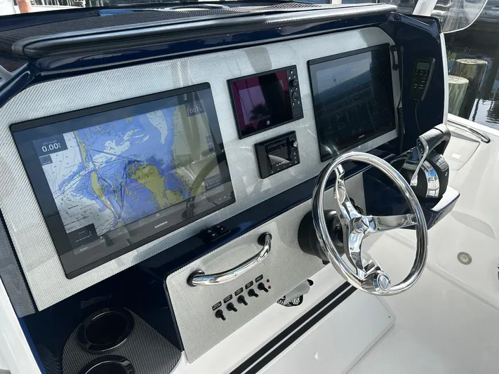  Yacht Photos Pics 2021 Nor-Tech 390 Sport Center Console dashboard with navigation screens and steering wheel.