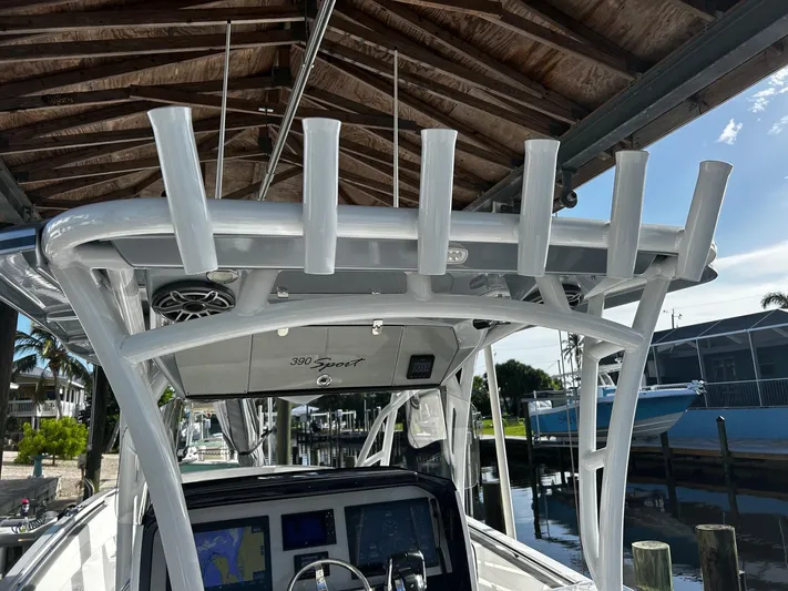  Yacht Photos Pics 2021 Nor-Tech 390 Sport Center Console boat docked under a wooden canopy.