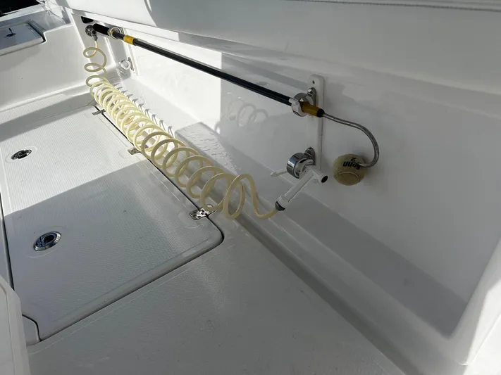  Yacht Photos Pics 2021 Nor-Tech 390 Sport Center Console deck with coiled hose and storage compartments.