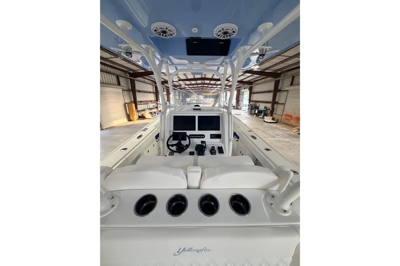  Yacht Photos Pics 2026 Yellowfin 32 Offshore boat interior with helm, steering wheel, and navigation screens.