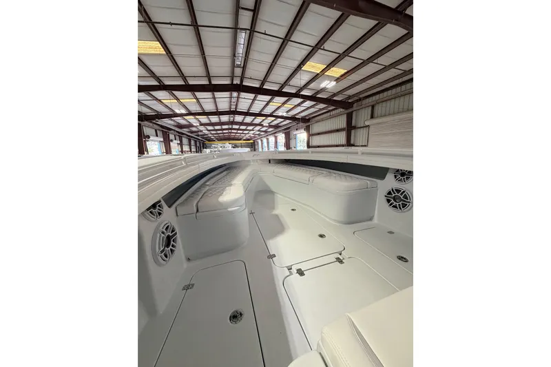  Yacht Photos Pics 2026 Yellowfin 32 Offshore boat interior with white seating and storage compartments.