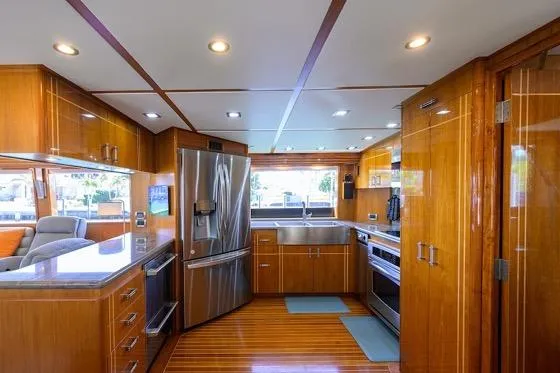 Pomboo Yacht Photos Pics Luxurious kitchen interior of 1998 Hatteras 70 Cockpit Motor Yacht with modern appliances.