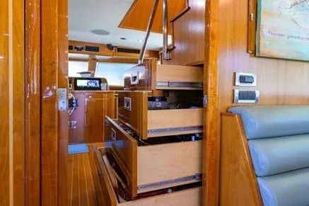 Pomboo Yacht Photos Pics Interior of 1998 Hatteras 70 Cockpit Motor Yacht with wooden cabinetry and seating.