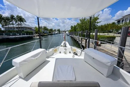Pomboo Yacht Photos Pics 1998 Hatteras 70 Cockpit Motor Yacht docked in a scenic marina setting.