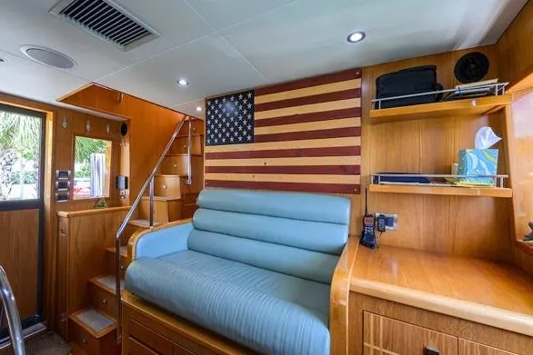 Pomboo Yacht Photos Pics Interior of 1998 Hatteras 70 Cockpit Motor Yacht with American flag decor and wooden furnishings.