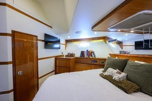 Pomboo Yacht Photos Pics Luxurious cabin interior of 1998 Hatteras 70 Cockpit Motor Yacht with modern amenities.