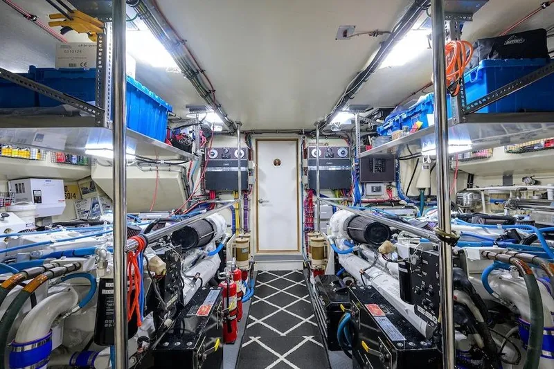 Pomboo Yacht Photos Pics Engine room of 1998 Hatteras 70 Cockpit Motor Yacht, featuring organized equipment and storage.