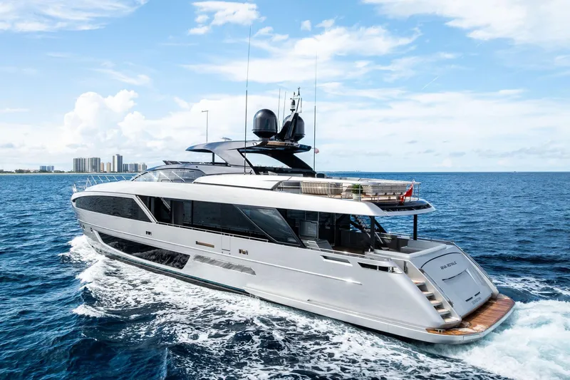 Riva Royale Yacht Photos Pics Luxury 2023 Riva 110' Dolcevita yacht cruising on open sea under blue sky.