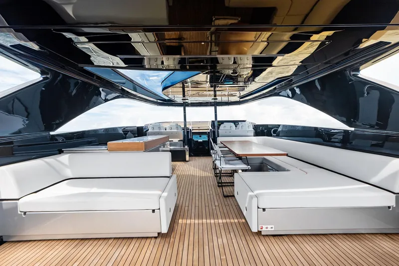 Riva Royale Yacht Photos Pics Luxurious interior of 2023 Riva 110' Dolcevita yacht with elegant seating and wooden flooring.