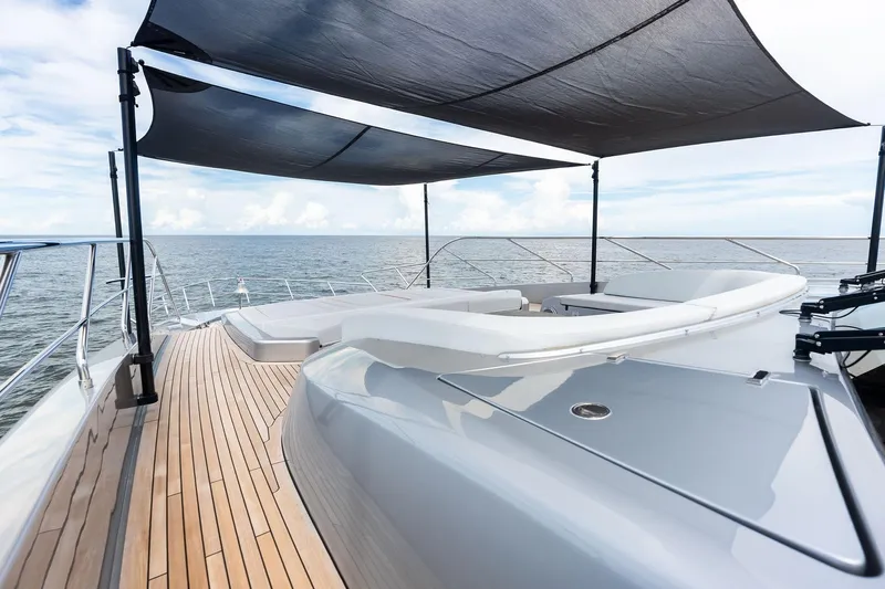 Riva Royale Yacht Photos Pics Luxurious 2023 Riva 110' Dolcevita yacht deck with sunshade, overlooking the ocean.