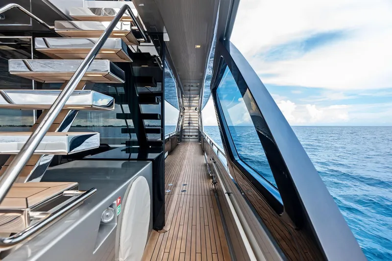 Riva Royale Yacht Photos Pics Luxurious 2023 Riva 110' Dolcevita yacht deck with ocean view and modern staircase.