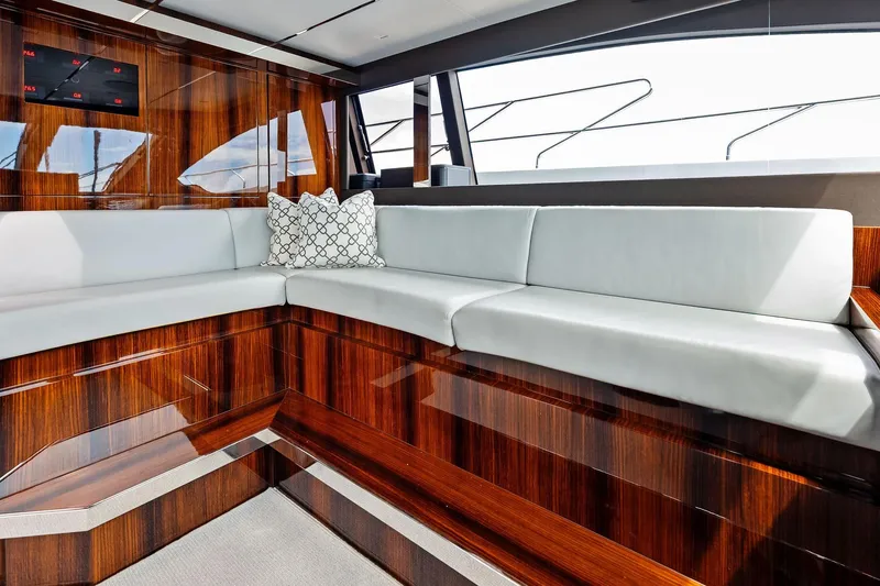 Riva Royale Yacht Photos Pics Luxurious interior of 2023 Riva 110' Dolcevita yacht with elegant wood finish and plush seating.
