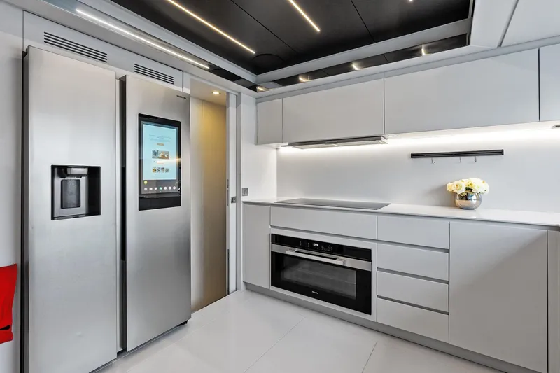 Riva Royale Yacht Photos Pics Modern kitchen interior on 2023 Riva 110' Dolcevita yacht, featuring sleek appliances and minimalist design.