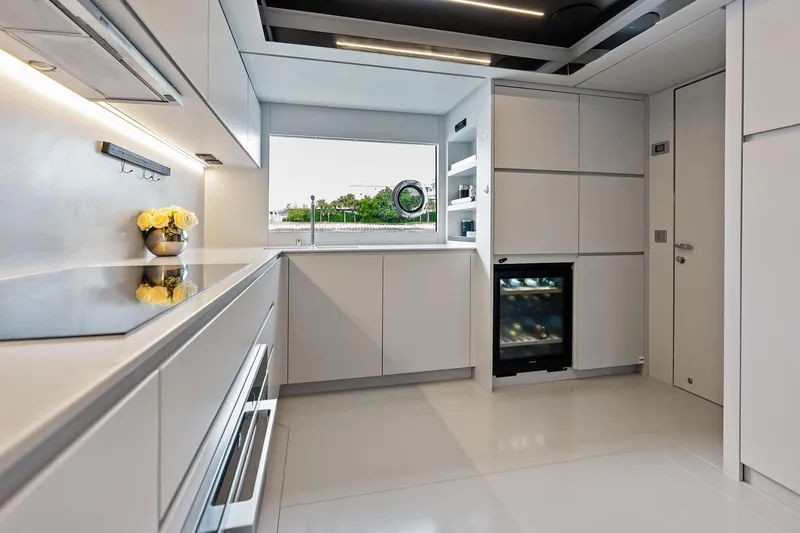 Riva Royale Yacht Photos Pics Modern kitchen interior on 2023 Riva 110' Dolcevita yacht, featuring sleek cabinetry and appliances.