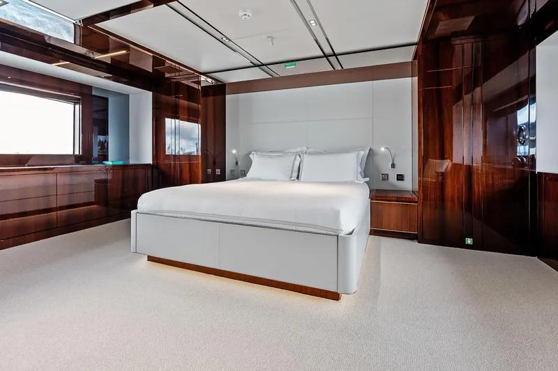 Riva Royale Yacht Photos Pics Luxurious bedroom interior on 2023 Riva 110' Dolcevita yacht with elegant wood finishes.