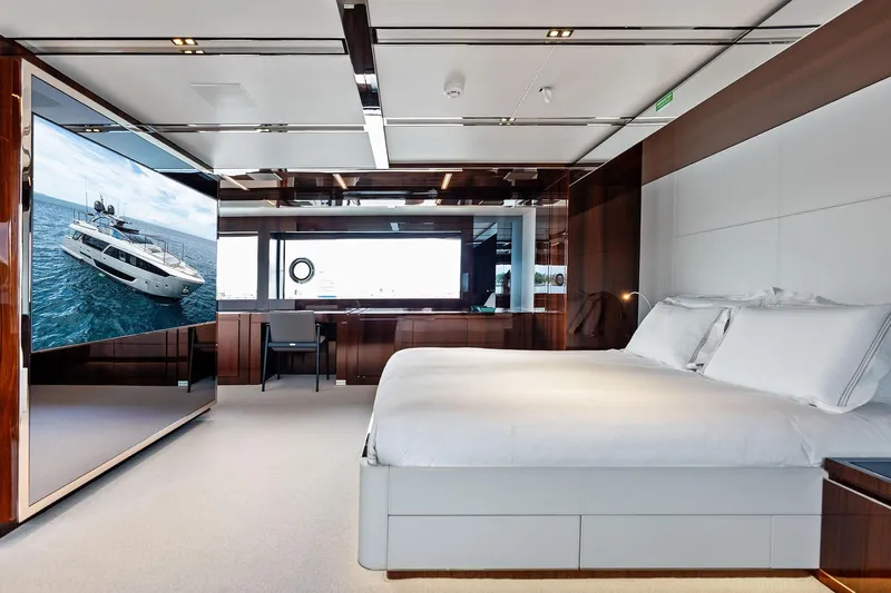 Riva Royale Yacht Photos Pics Luxurious bedroom interior on 2023 Riva 110' Dolcevita yacht with modern design and large TV.
