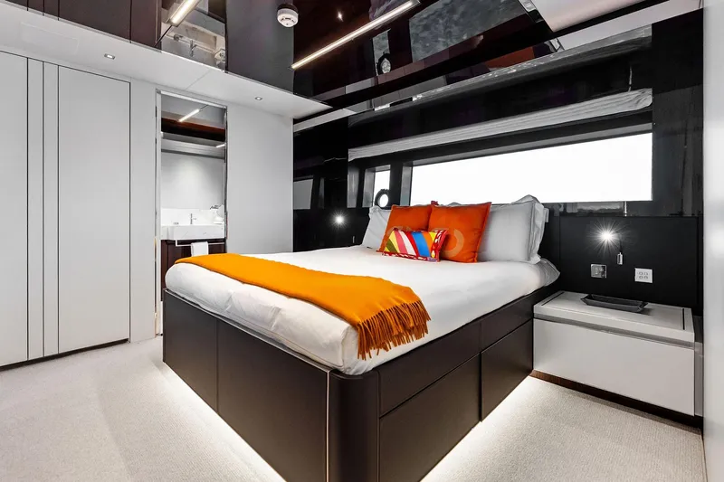Riva Royale Yacht Photos Pics Luxurious bedroom interior on 2023 Riva 110' Dolcevita yacht with modern design and vibrant accents.