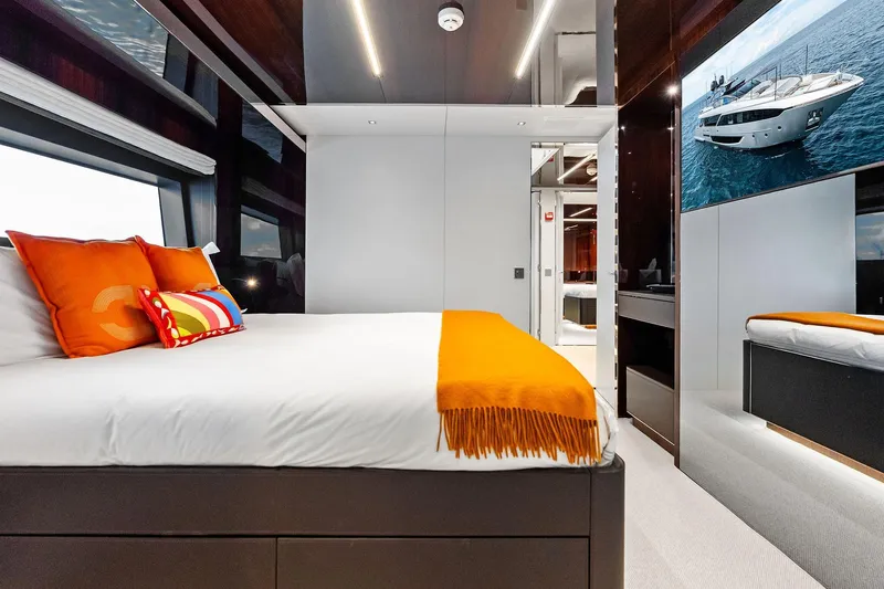 Riva Royale Yacht Photos Pics Luxurious bedroom interior of 2023 Riva 110' Dolcevita yacht with vibrant orange accents.