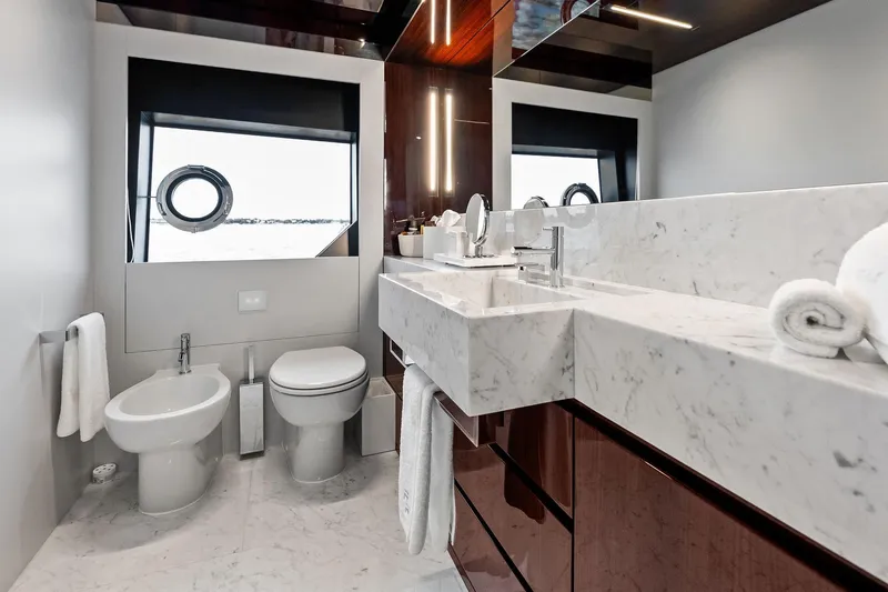 Riva Royale Yacht Photos Pics Luxurious bathroom on 2023 Riva 110' Dolcevita yacht with marble sink and modern fixtures.