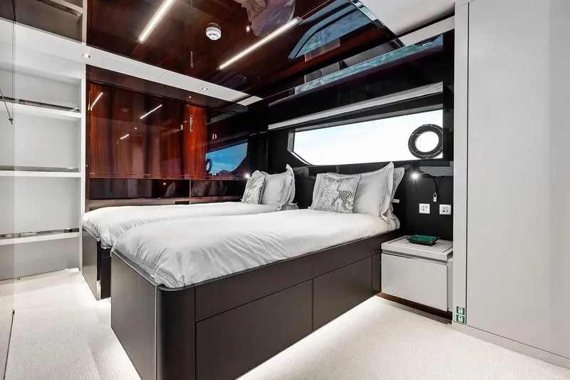 Riva Royale Yacht Photos Pics Luxurious bedroom interior of 2023 Riva 110' Dolcevita yacht with twin beds and modern design.