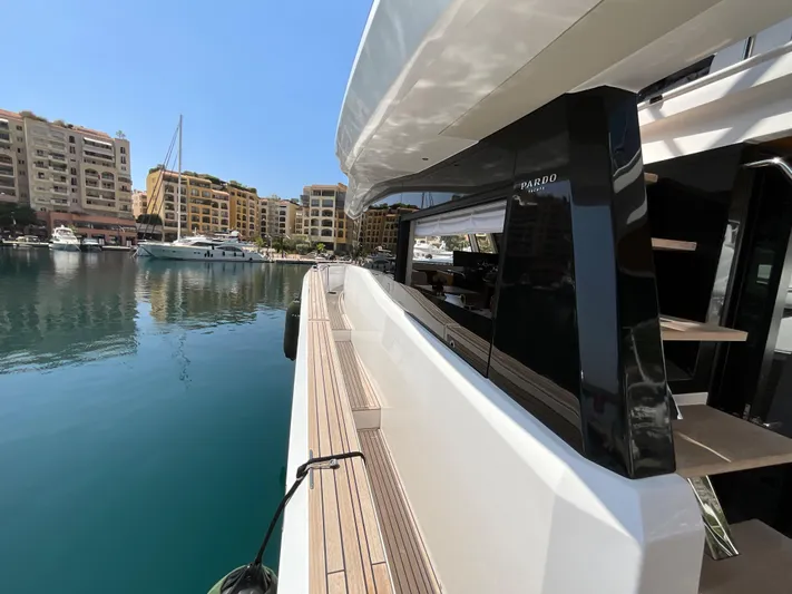  Yacht Photos Pics Pardo Yachts 60 E 2020 model docked in a marina with waterfront buildings.