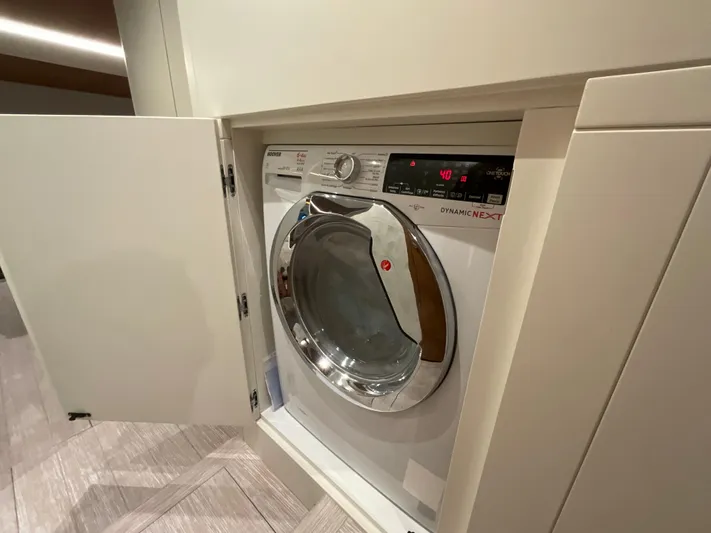  Yacht Photos Pics Built-in washing machine on Pardo Yachts 60 E, 2020 model, with open cabinet door.