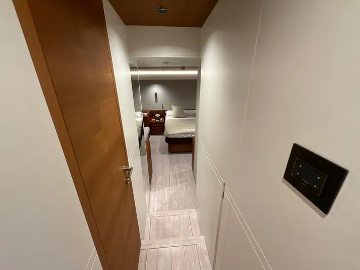  Yacht Photos Pics Interior hallway of 2020 Pardo Yachts 60 E, leading to a cozy bedroom.