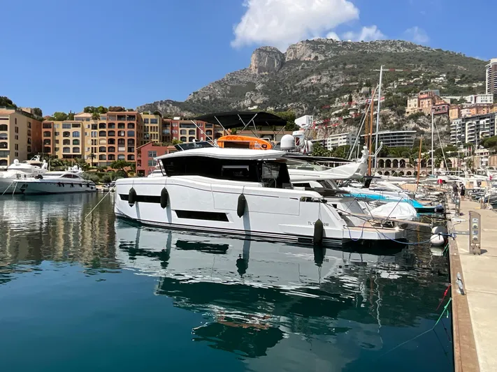  Yacht Photos Pics Pardo Yachts 60 E 2020 docked in scenic marina with mountains and colorful buildings.