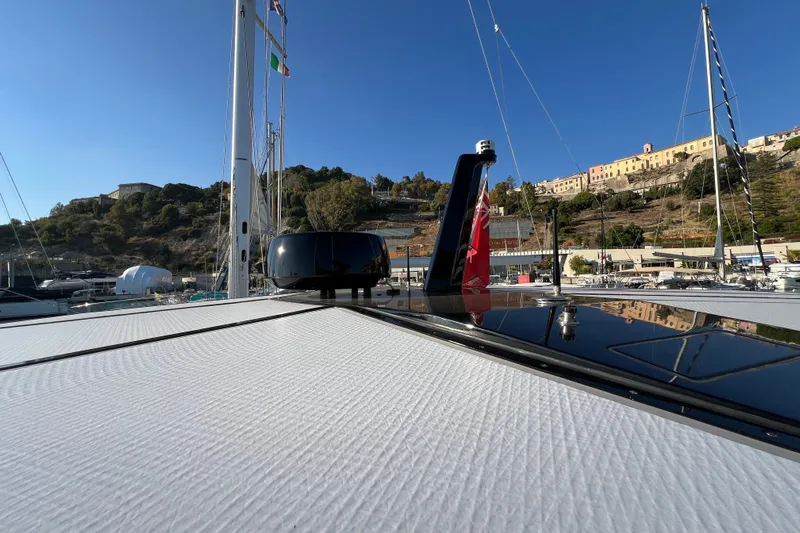  Yacht Photos Pics 2024 Wally Tender 43 X yacht docked in scenic marina with hillside view.