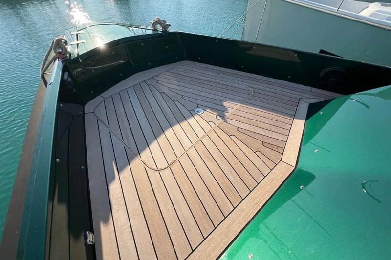  Yacht Photos Pics 2024 Wally Tender 43 X boat deck with sleek wood finish, docked on calm water.