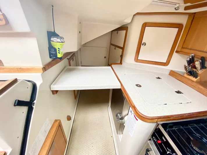 Licentia Yacht Photos Pics 2008 Catalina 42 MkII yacht interior with compact kitchen and storage cabinets.