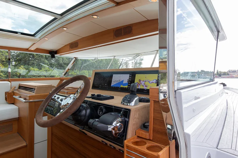  Yacht Photos Pics Interior view of 2011 Delta Powerboats 54 Carbon IPS helm with navigation screens.