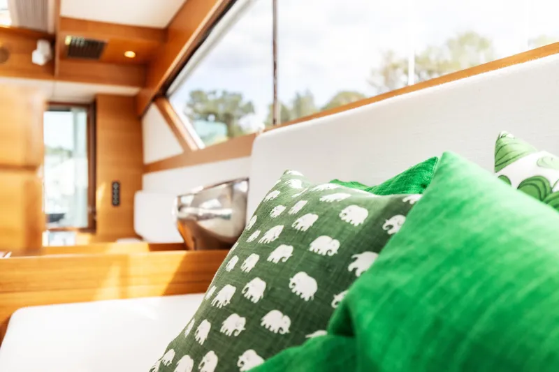  Yacht Photos Pics Interior of 2011 Delta Powerboats 54 Carbon IPS with green elephant-patterned cushions.