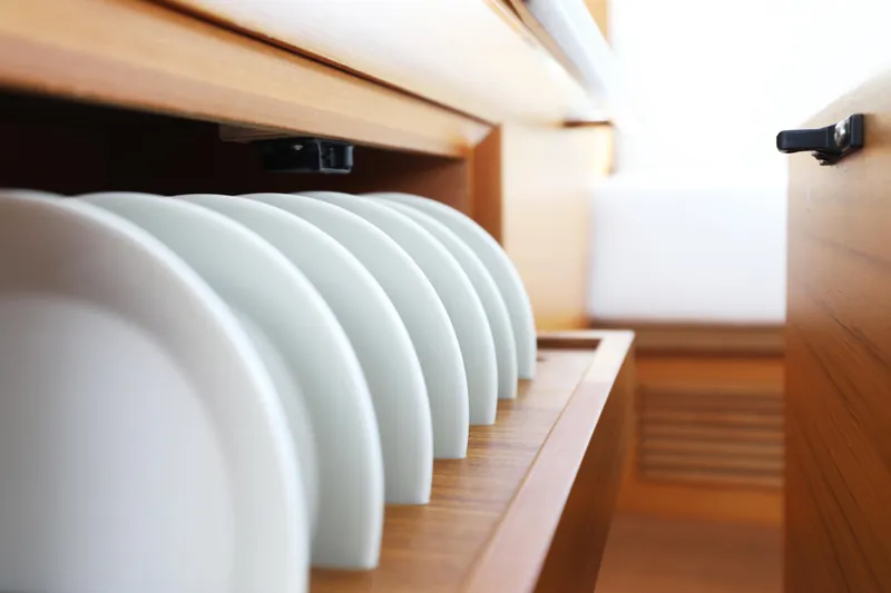  Yacht Photos Pics Plates neatly arranged in a wooden drawer on a 2011 Delta Powerboats 54 Carbon IPS.