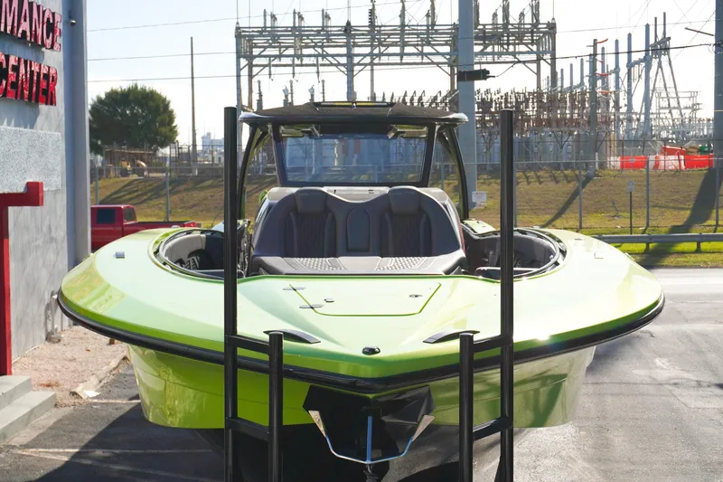  Yacht Photos Pics 2022 MTI 50V Center Console boat in vibrant green, parked outdoors.