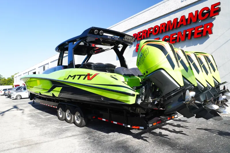  Yacht Photos Pics 2022 MTI 50V Center Console boat with vibrant green design and multiple engines.