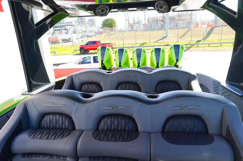  Yacht Photos Pics 2022 MTI 50V Center Console boat interior with luxurious seating and vibrant green accents.