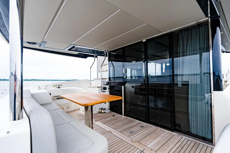 The Transporter Yacht Photos Pics Luxurious 2023 Absolute 52 Navetta yacht with spacious deck and elegant seating area.