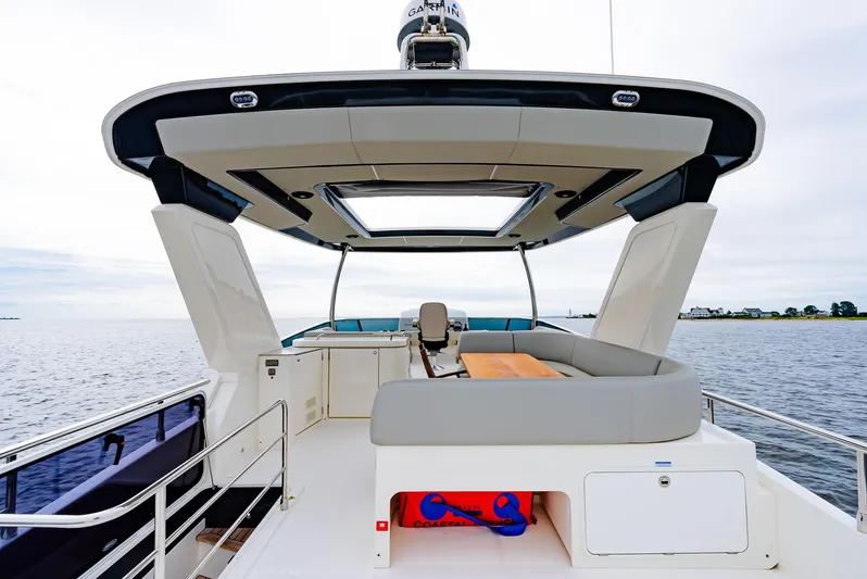 The Transporter Yacht Photos Pics 2023 Absolute 52 Navetta yacht deck with seating and open water view.