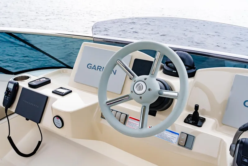 The Transporter Yacht Photos Pics Helm of 2023 Absolute 52 Navetta yacht with steering wheel and navigation equipment.