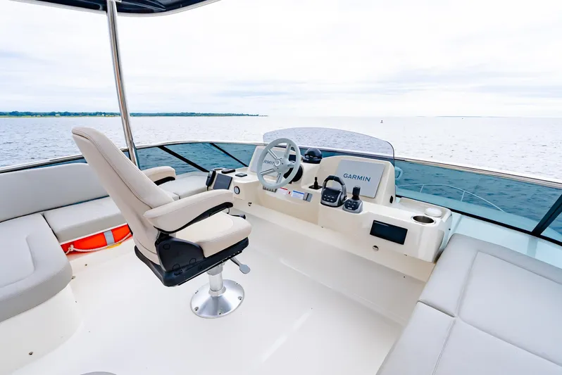 The Transporter Yacht Photos Pics Helm of 2023 Absolute 52 Navetta yacht with modern controls and ocean view.