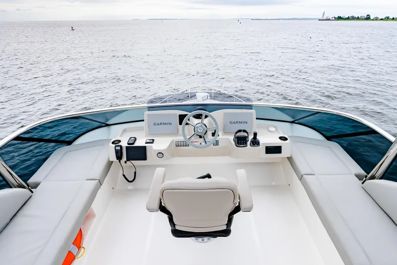 The Transporter Yacht Photos Pics Cockpit view of 2023 Absolute 52 Navetta yacht with dual Garmin displays on open water.