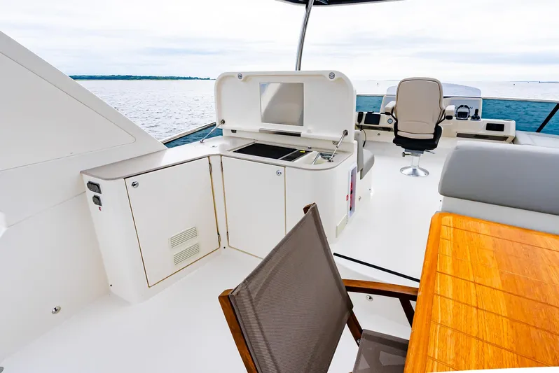 The Transporter Yacht Photos Pics Luxurious 2023 Absolute 52 Navetta yacht deck with seating and kitchenette.