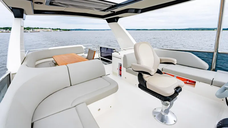 The Transporter Yacht Photos Pics Luxurious seating area on 2023 Absolute 52 Navetta yacht with scenic water view.